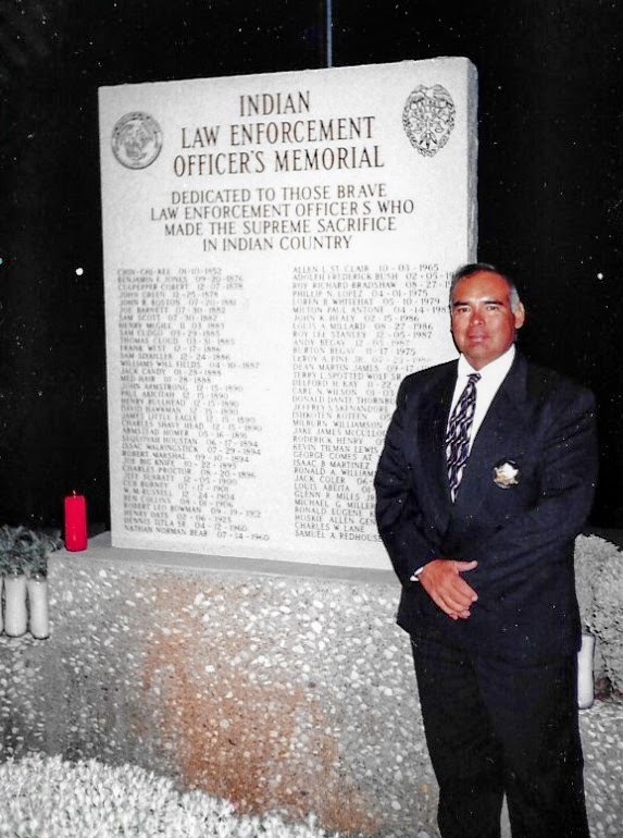 Dennis Bacoch standing in front of the Indian Law Enforcement Officers Memorial.